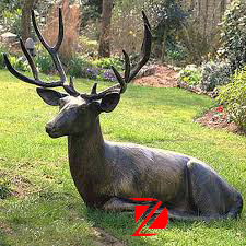 Lying garden deer statue
